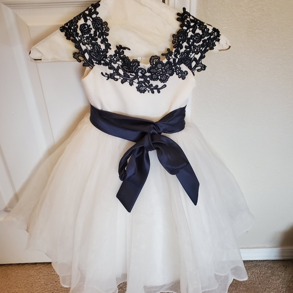 white dress with blue ribbon